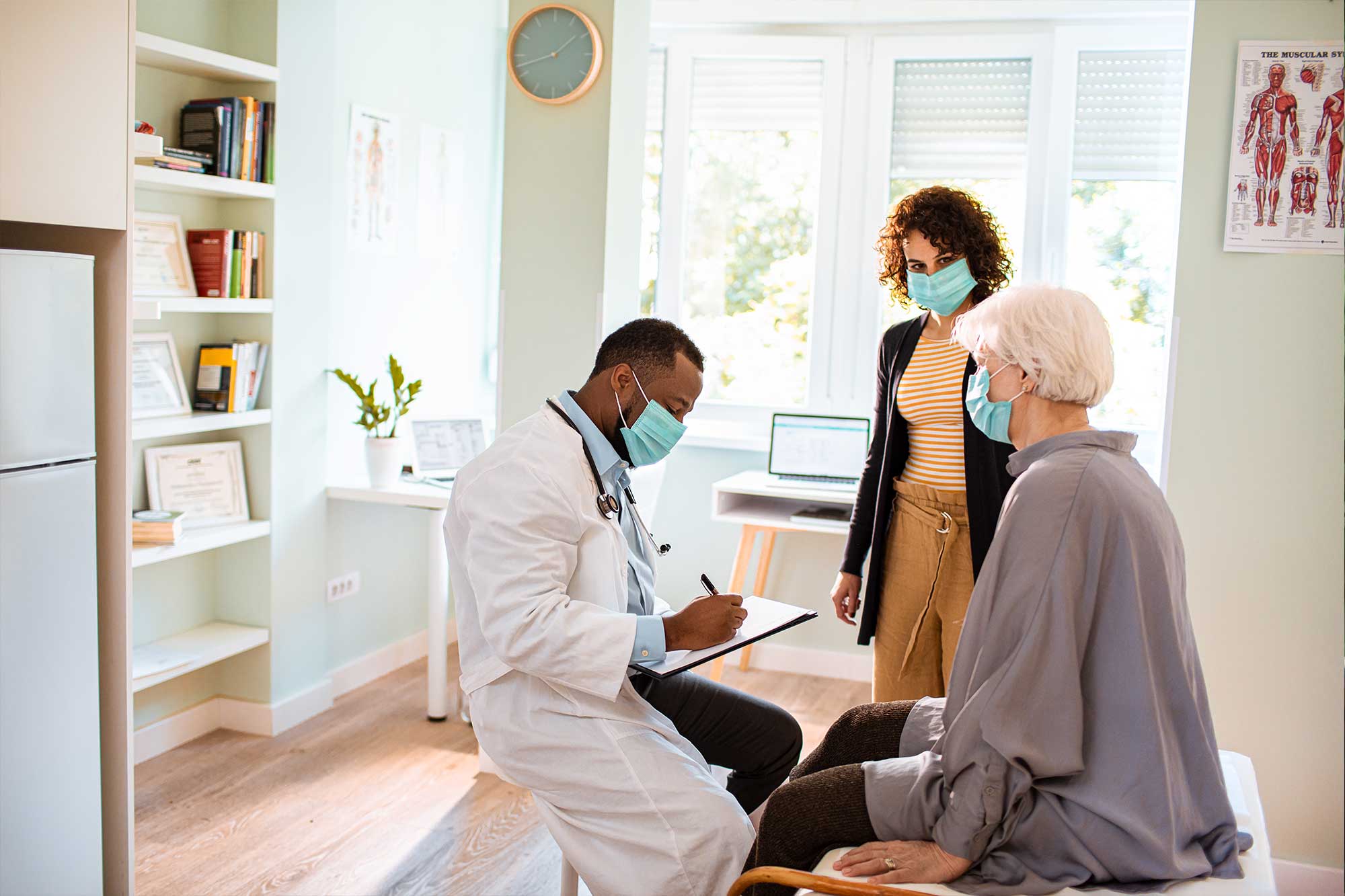Photograph of a doctor writing up a lab order
